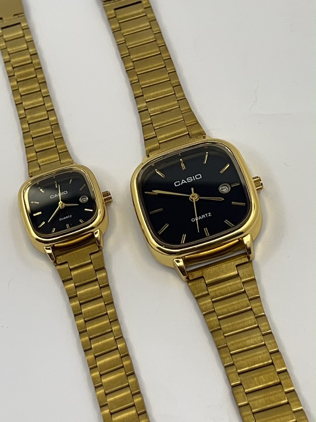 Gold square Casio watches with black dials and metal link bracelets