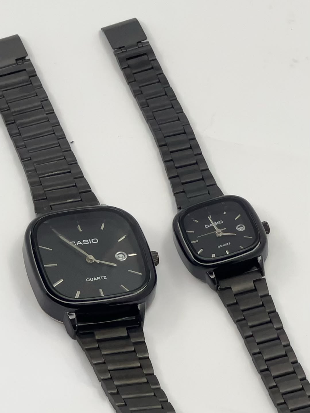 Silver square Casio watches with light dials and metal link bracelets